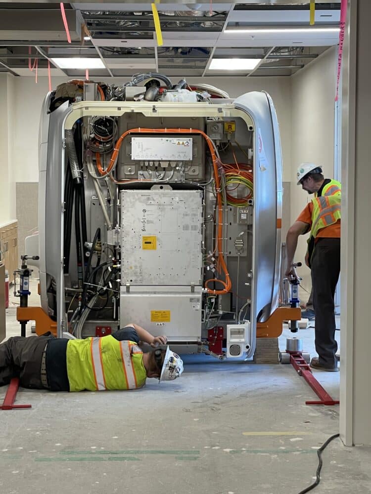 Installation involved aligning the machines’ framework with the floor’s braces. © Hensel Phelps