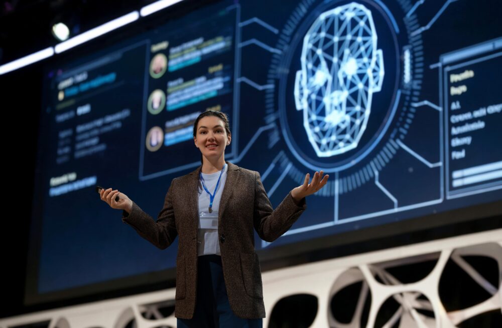 Medical professionals are discussing the topic of agentic AI on global platforms. Here, we see an example of a woman speaking about technology in the industry. Image via Envato
